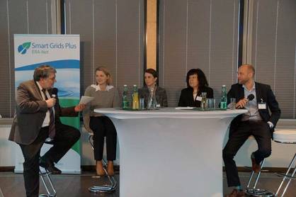 Five persons speak sitting on a podium